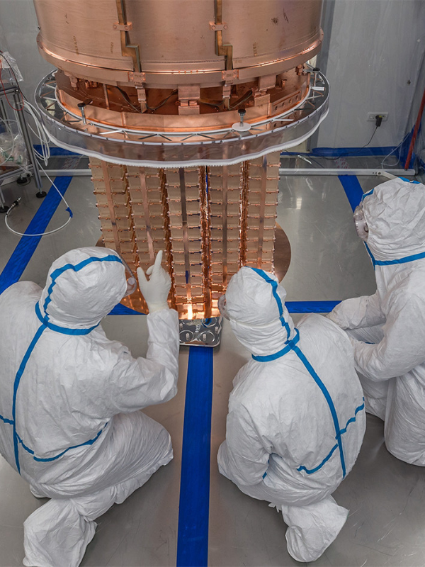 Researchers working on CUORE inside a clean room. The detector is designed to search for signals from a process never before observed in physics: neutrinoless double beta decay. ©Yury Suvorov/CUORE Collaboration